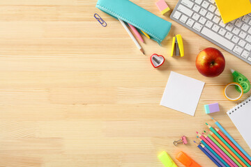 Back to school concept. Colorful school supplies on wooden desk table. Flat lay, top view.