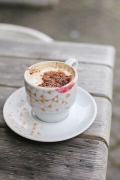 A cup of coffee wit lipstick mark on it 