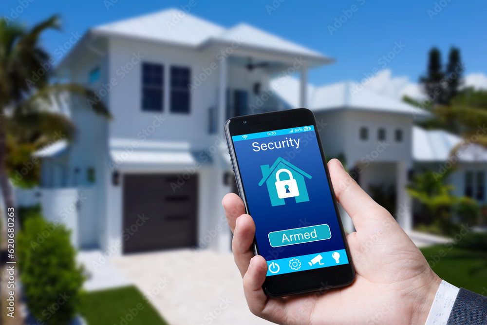 Aufkleber smartphone with home security app in a hand on the building background.