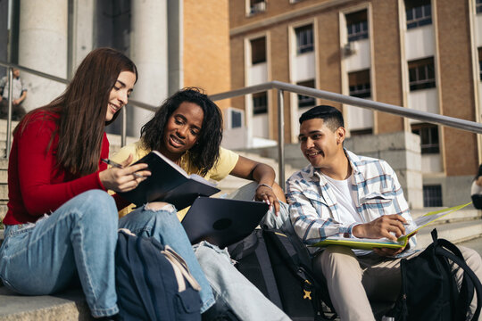Friends University Students Review Assignment Outside On Campus