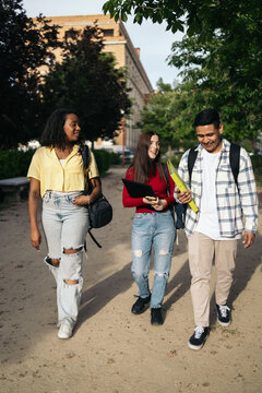 Young Students Walking Outside At University