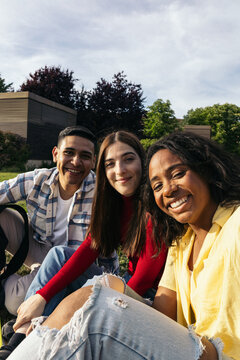 Selfie of a multiracial group of students in the campus gardens