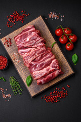 Fresh raw beef ribs with salt, spices and herbs