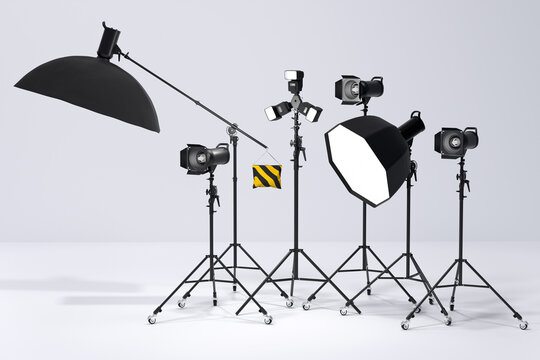 Photography studio flash on a lighting stand on white background