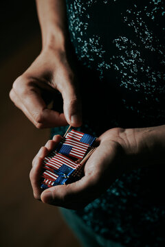man with mini US flags in his hands