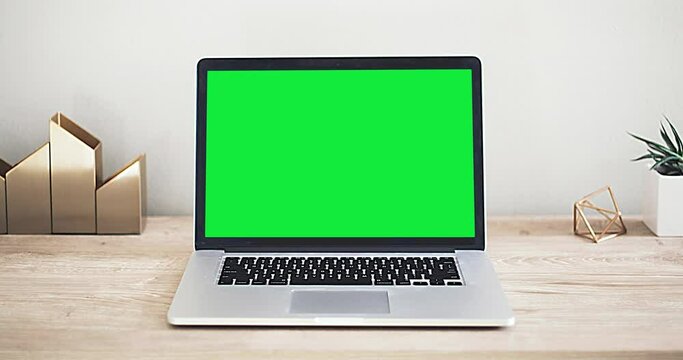 Laptop with green screen in the office