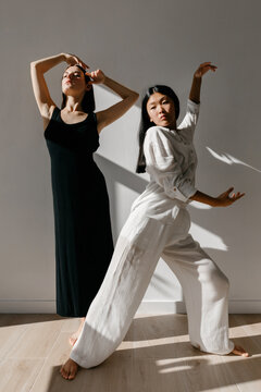 Graceful diverse ballerinas dancing together in studio