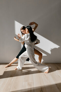 Flexible diverse women performing ballet dance pose