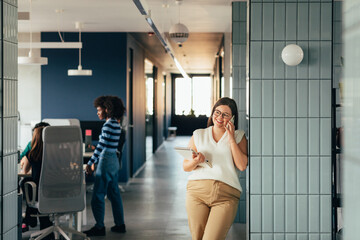 Young Businesswoman in Office Talking on Phone
