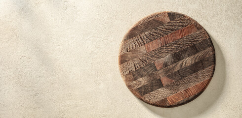 Fototapeta na wymiar Old pizza board or cutting board on sand stone texture