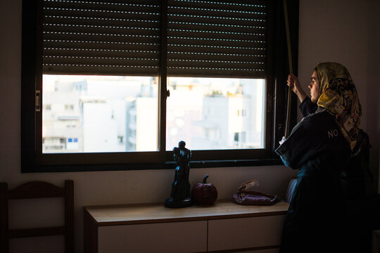 Person closing a window of a bedroom