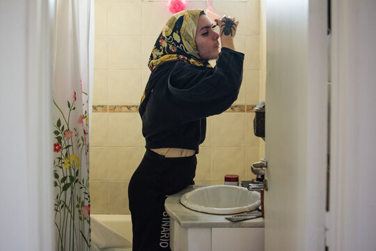 Person in the bathroom applying make up