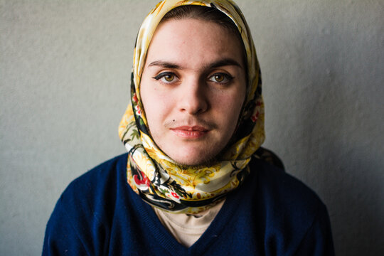 Trans muslim person indoors portrait