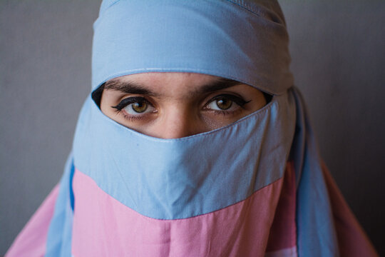Transgender person close up with trans colors niqab