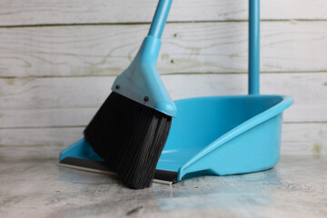 Broom with brush and dustpan. Blue plastic kit for cleaning trash and waste. House cleaning