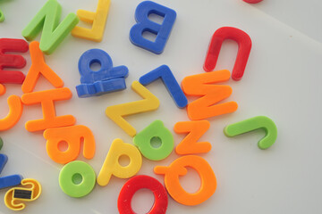 colorful plastic letters on white background, close up 