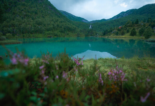 Pristine turquoise lake in Norway surrounded by mountains 