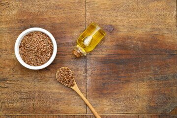 Flax seeds. Flaxseed powder in a wooden spoon. Standing on a Wooden background.