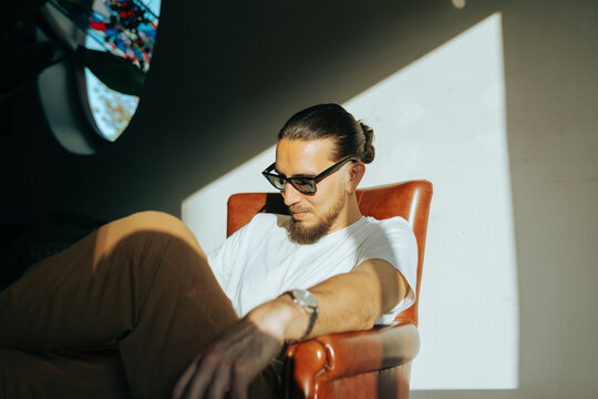 Pensive Man on Leather Couch