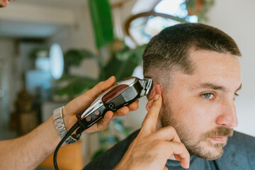 Close-up of a barber giving a transformation to a client
