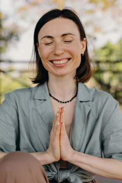 Woman practicing yoga with hands in namaste