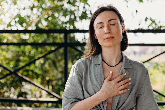 Woman praying with closed eyes before Thai treatment