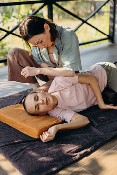 Female masseuse massaging back of client