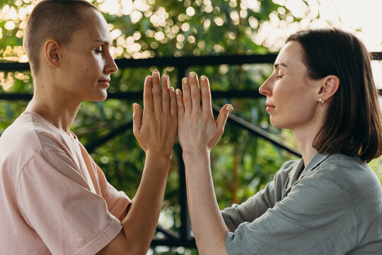 Relaxed women practicing meditation together in park