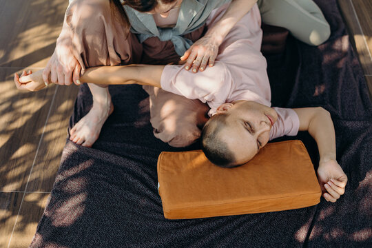 Crop woman doing Thai massage to client