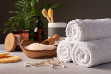 Bathroom accessories: towels, toothbrushes, sea salt, cotton swabs and cosmetic bottles.