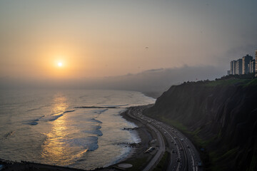 Winding road during the Sunset in la Costa Verde (Green Coast) in Lima, Peru - 620695867