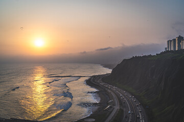 Winding road during the Sunset in la Costa Verde (Green Coast) in Lima, Peru - 620695894