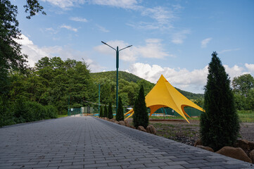 yellow summer tent on vacation in park for recreation