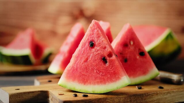 Watermelon stock video 4k. Slices of fresh watermelon on the rustic wooden table