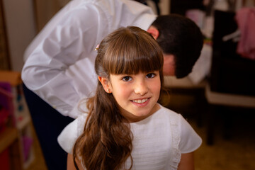 Cheerful little girl in first communion dress