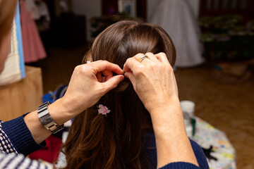 Mom adjusting her daughter's hair