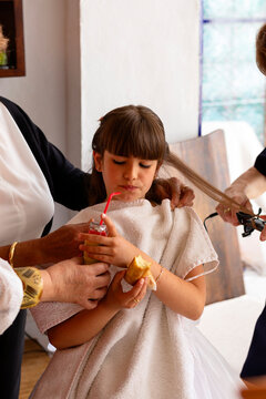 Family preparing the girl for her first communion.