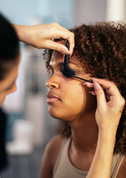 Makeup Artist Applying Mascara On A Woman's Eyelashes