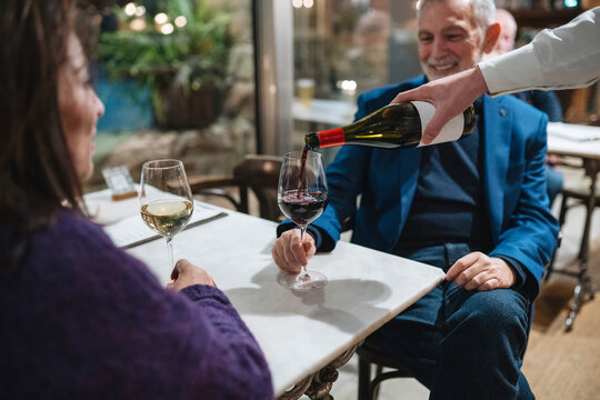 Crop couple having dinner in restaurant