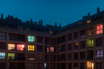 Colourful illuminated home windows at night