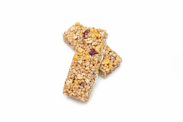 Two muesli bars on a white isolated background. Healthy sweet dessert snack. Cereal muesli with nuts, oatmeal and berries on a white background. Delicious and healthy dessert