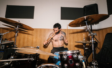 Bearded musician playing drums in studio