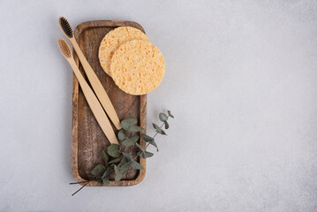 Two bamboo toothbrush and facial sponges