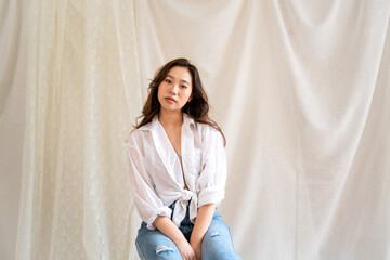 Asian woman posing in studio.