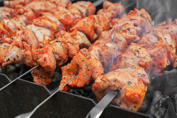 Pork skewers, roasted on skewers on the grill. Shashlik meat shish kebab on the grill. traditional outdoor barbecue picnic.