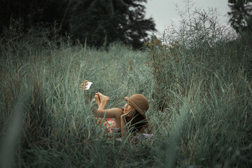 girl wearing a hat taking a selfie in the field