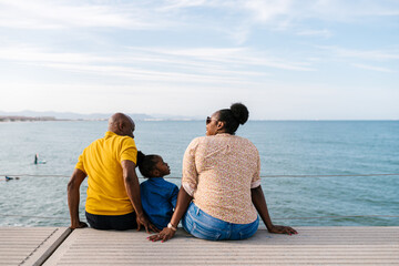 Happy family spending weekend on embankment