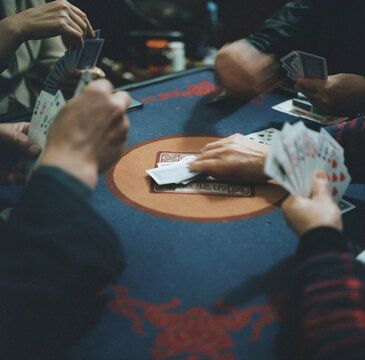 Four people are playing Chinese poker
