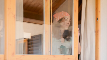 Woman opening a window to ventilate the room