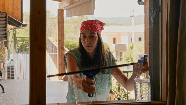 woman rubing a window